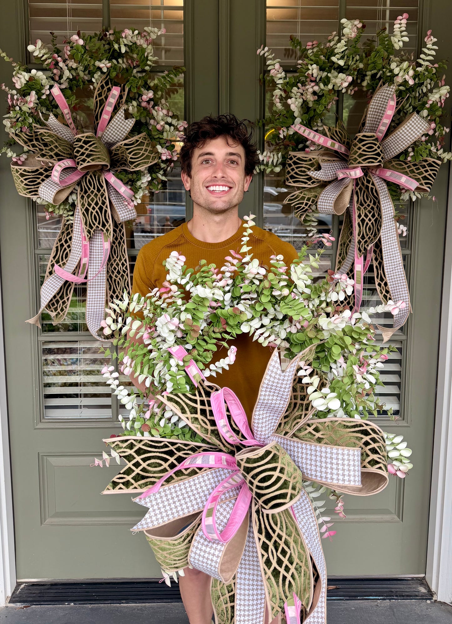 Faux eucalyptus wreath paired with a JME hand tied bow. About 24 inches in diameter.