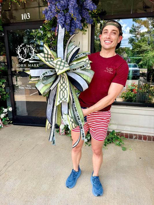 JME lux ribbon bow made with greens, tans, and neutral tones. Hand-tied by JME. Approximately 22 inches wide and 32 inches long.