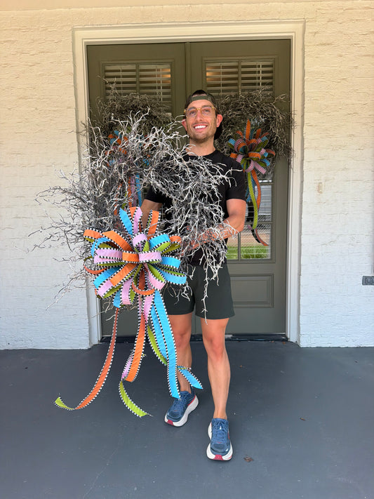 Branchy wreath paired with a hand tied JME bow. Spooky colors for the spooky season! About 28 inches in diameter. * some fluffing may be required upon receiving.