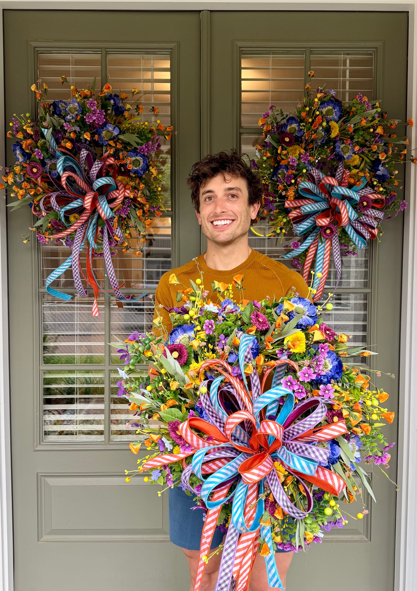Summertime JME handmade wreath. Made with faux florals and paired with a JME hand tied bow. About 24 inches in diameter.