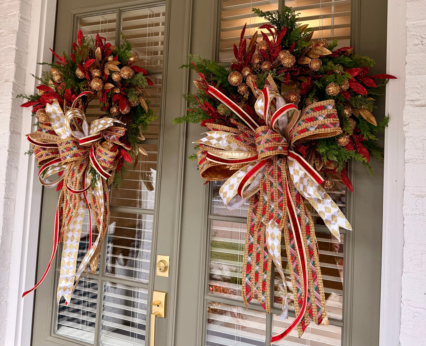 Red green gold faux wreath. Very full hand made wreath by JME and tied with a JME bow. About 30 inches wide