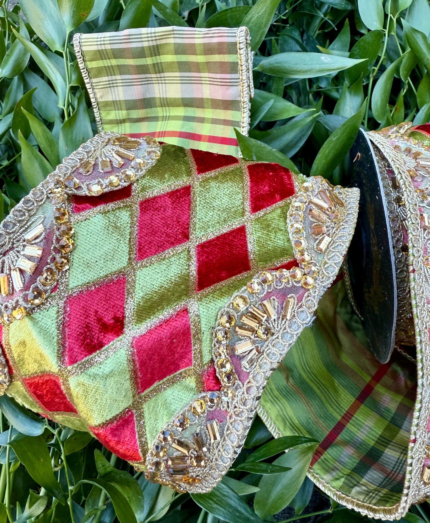 JME heavy wired ribbon. Red/green Harlequin velvet with gold scalloped jeweled trim. With a green and red plaid back. 4“ x 5 yards.