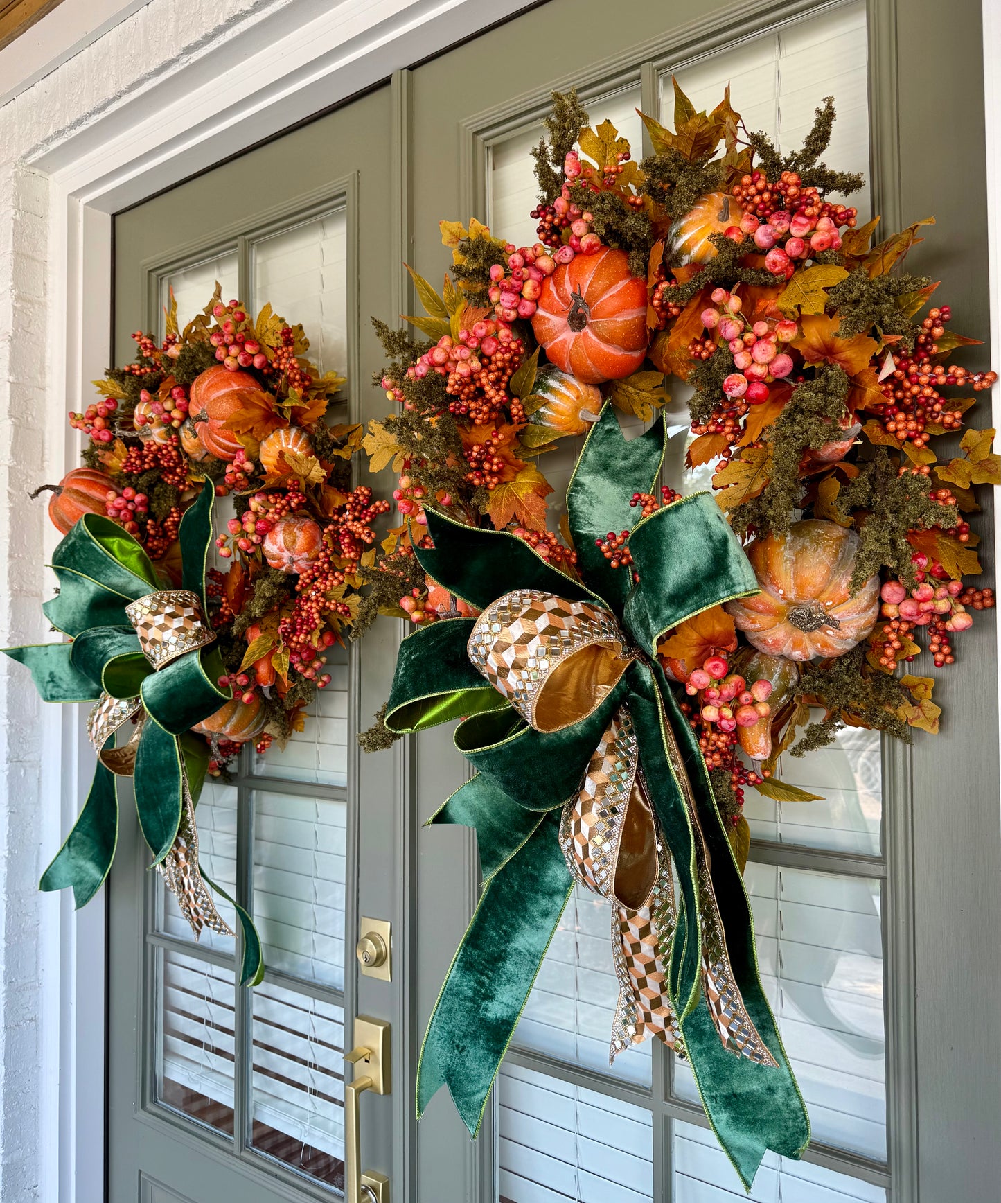 Faux moss and pumpkin JME wreath with A JME bow tied to it. About 30 inches.