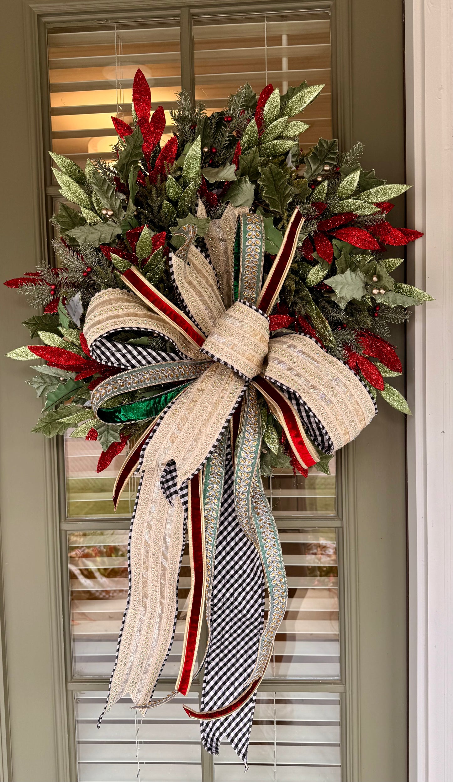 Sage, red, and green faux wreath made by JME paired with a hand tied JME bow with a touch of black and white! Very full About 24 inches wide