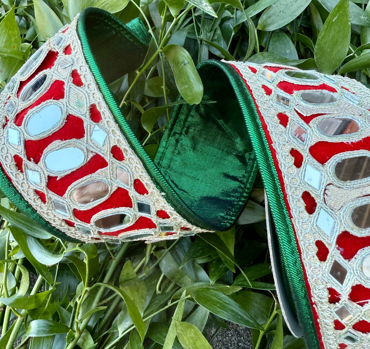 JME heavy wired ribbon. Red ribbon with mirrors. 2.5” x 5 yards. Back with green metallic ribbon and piped.