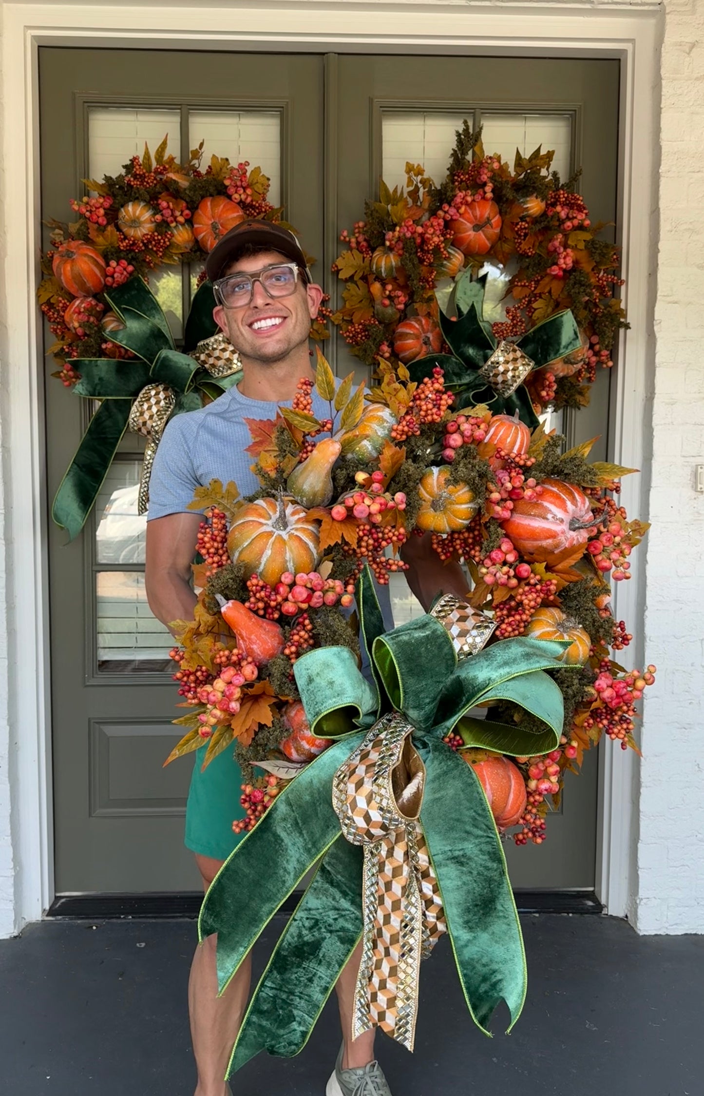 Faux moss and pumpkin JME wreath with A JME bow tied to it. About 30 inches.