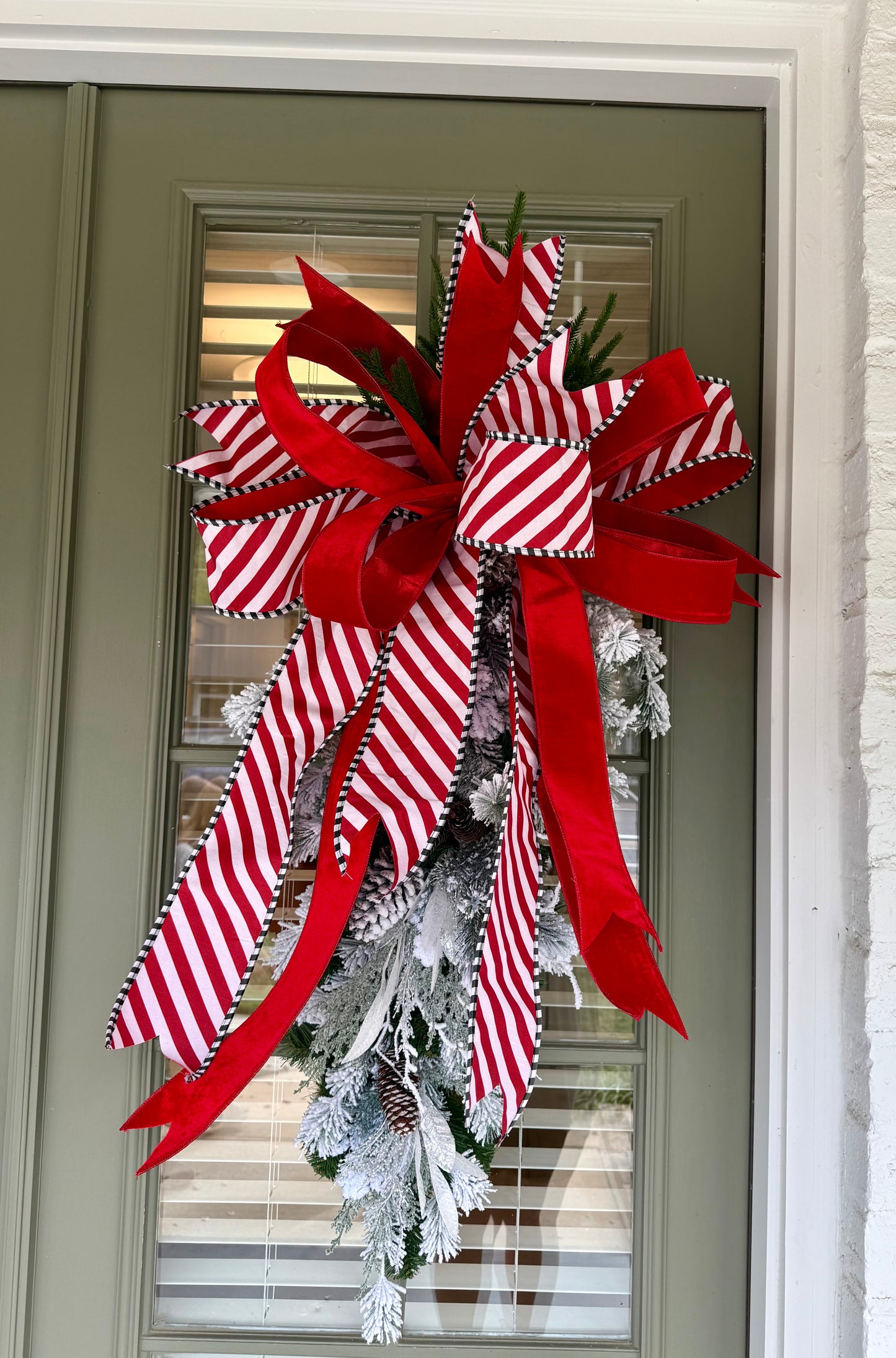 Candy Cain inspired door swag. Flocked and paired with a JME hand-tied bow.