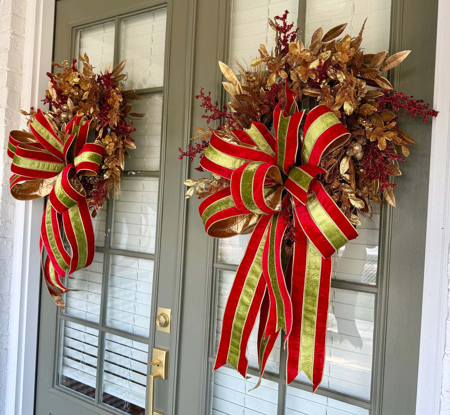 Faux gold and red regal JME Christmas wreath with hand, tied JME red and green striped velvet bow. About 24 inches wide. 