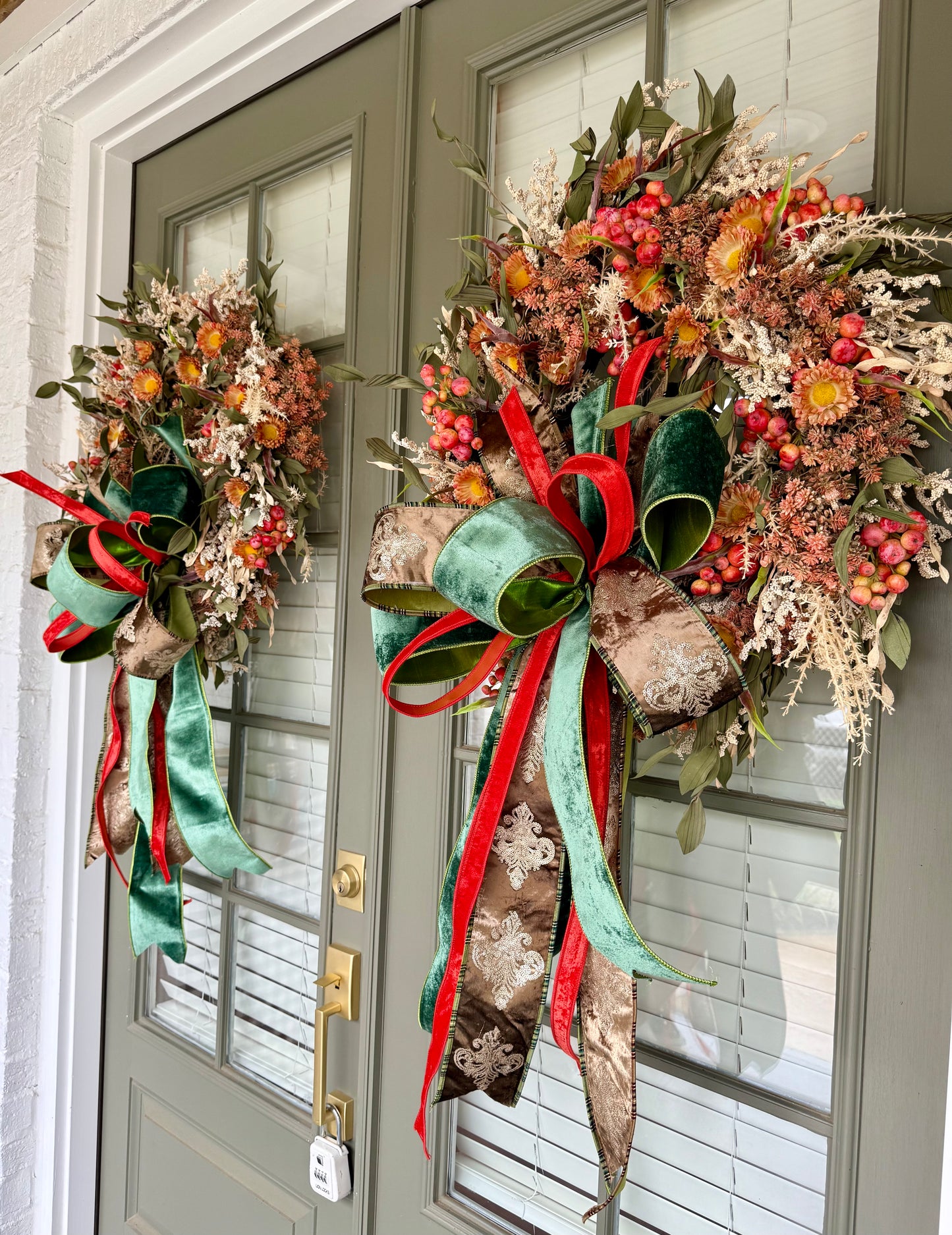 Green brown and orange faux fall wreath with hand tied JME bow. About 24 inches wide
