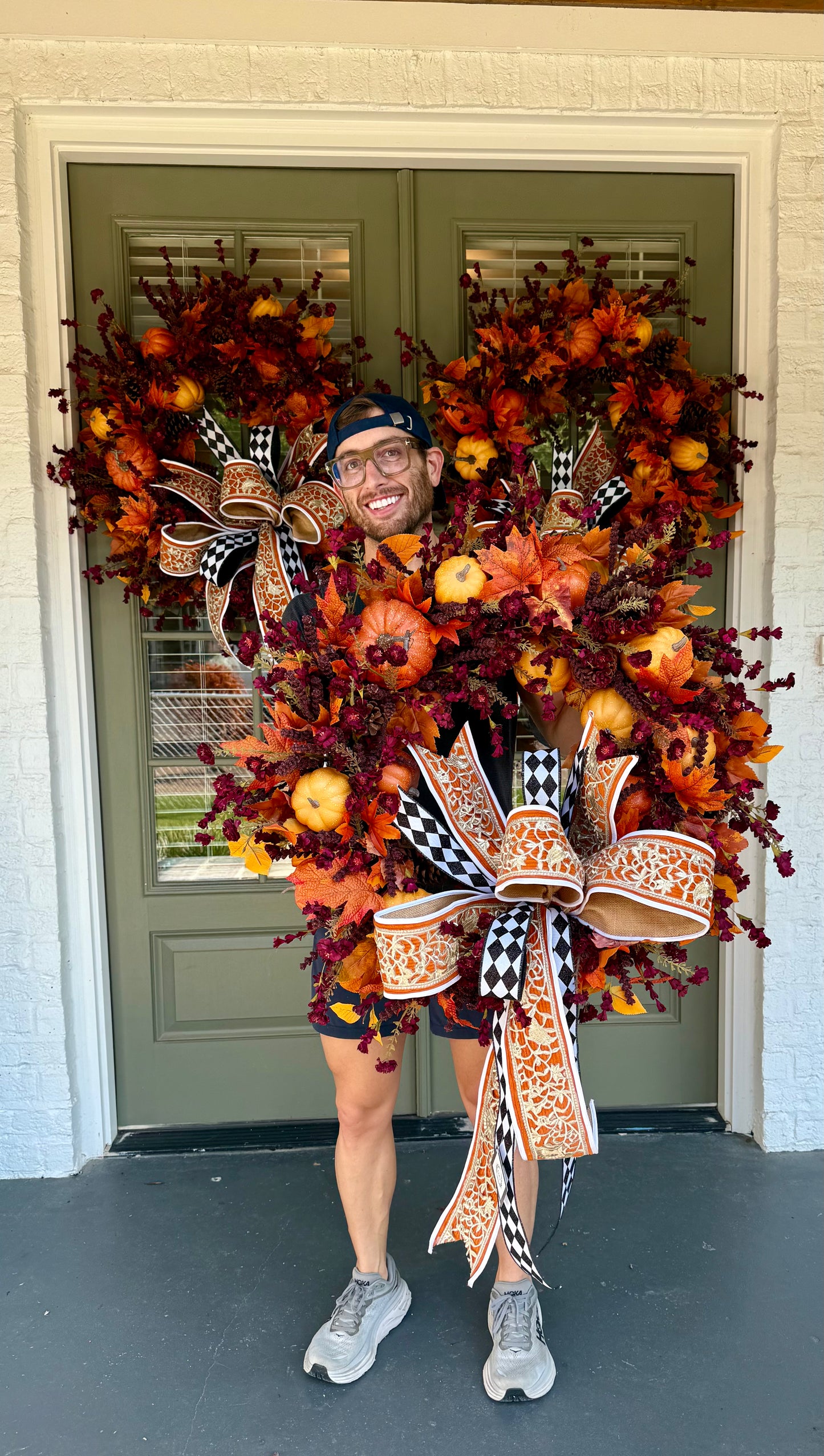 Handmade JME wreath of burgundy and pumpkins. Paired with a JME hand tied bow. About 32 inches wide. SHIPPING Monday August 18th.
