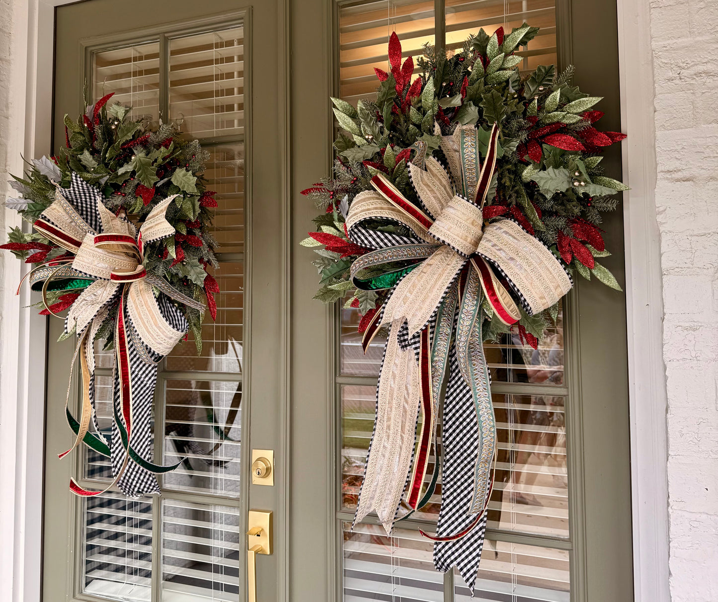 Sage, red, and green faux wreath made by JME paired with a hand tied JME bow with a touch of black and white! Very full About 24 inches wide