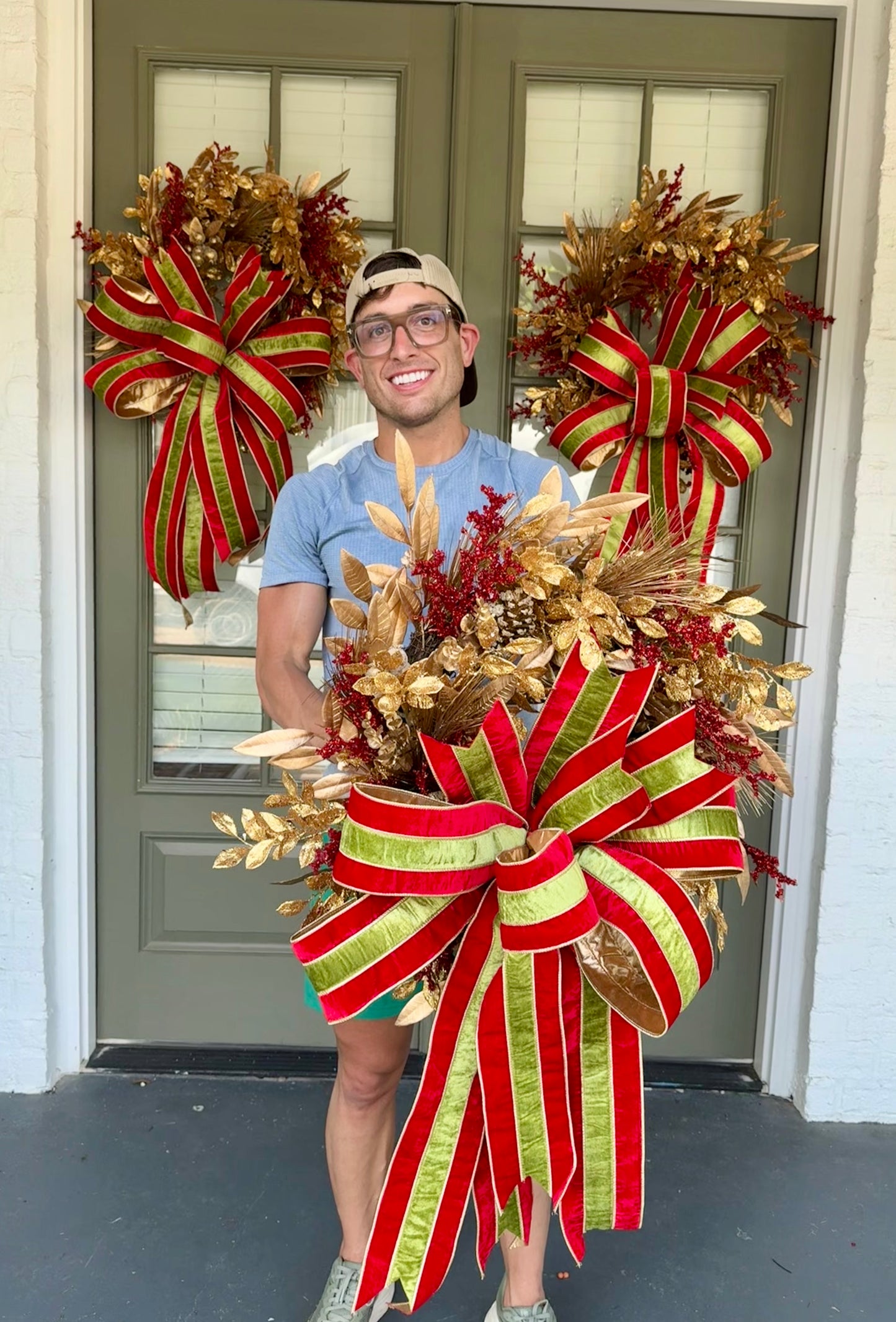 Faux gold and red regal JME Christmas wreath with hand, tied JME red and green striped velvet bow. About 24 inches wide. 