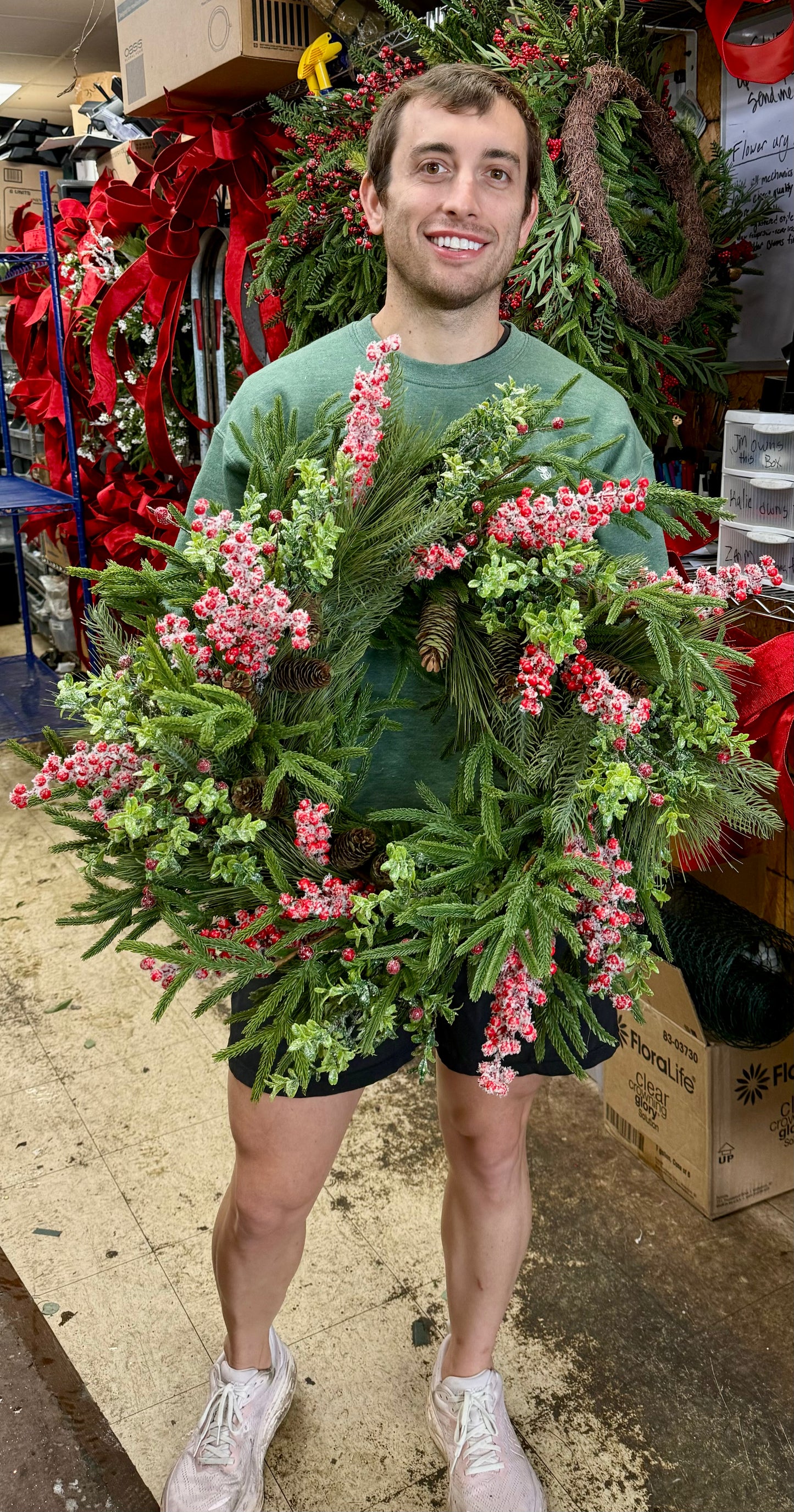 24 inch hand made by JME WREATH. Red snowberries with different textures of Christmas greenery.