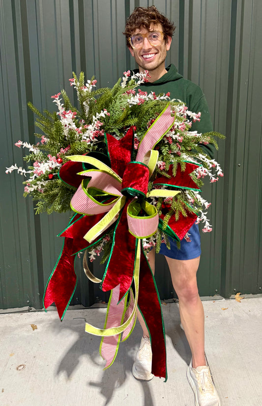 Faux Christmas wreath with white branches and jingle bells. Hand made with a JME handtied bow. About 24 inches wide.