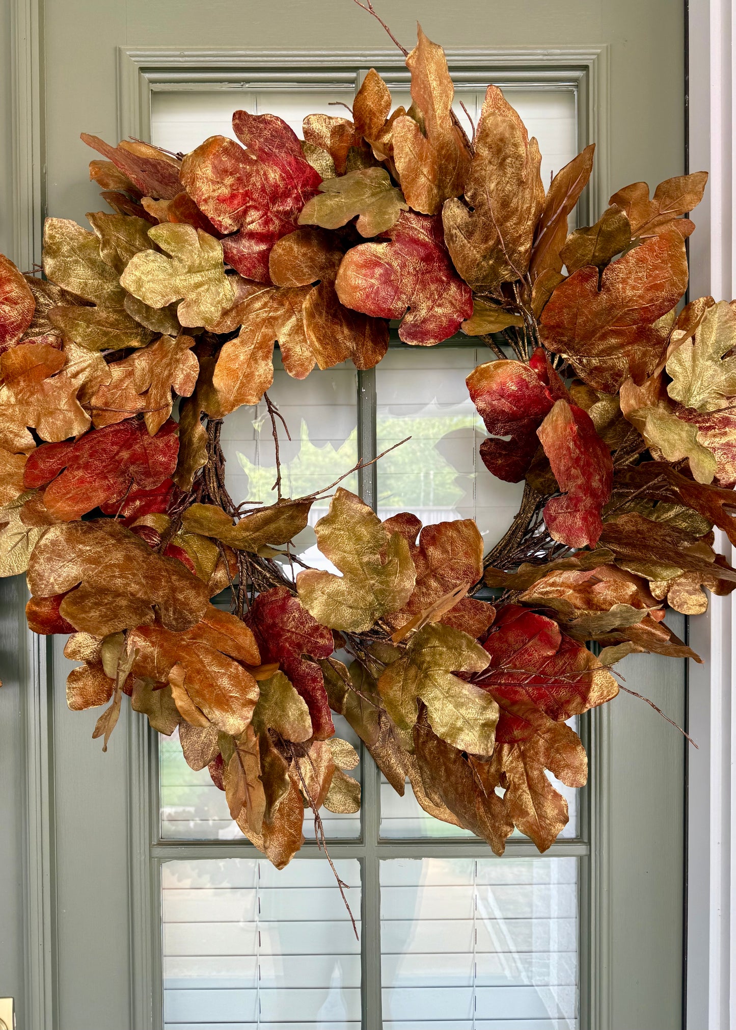 Faux oak leaf wreath with bronze brushing. About 30 inches wide.