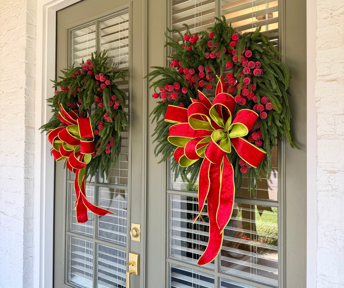 JME faux pine wreath with red berries and a  JME red velvet bow with chartreuse accents. About 26 inches in diameter. Some fluffing may be required upon receiving. ￼