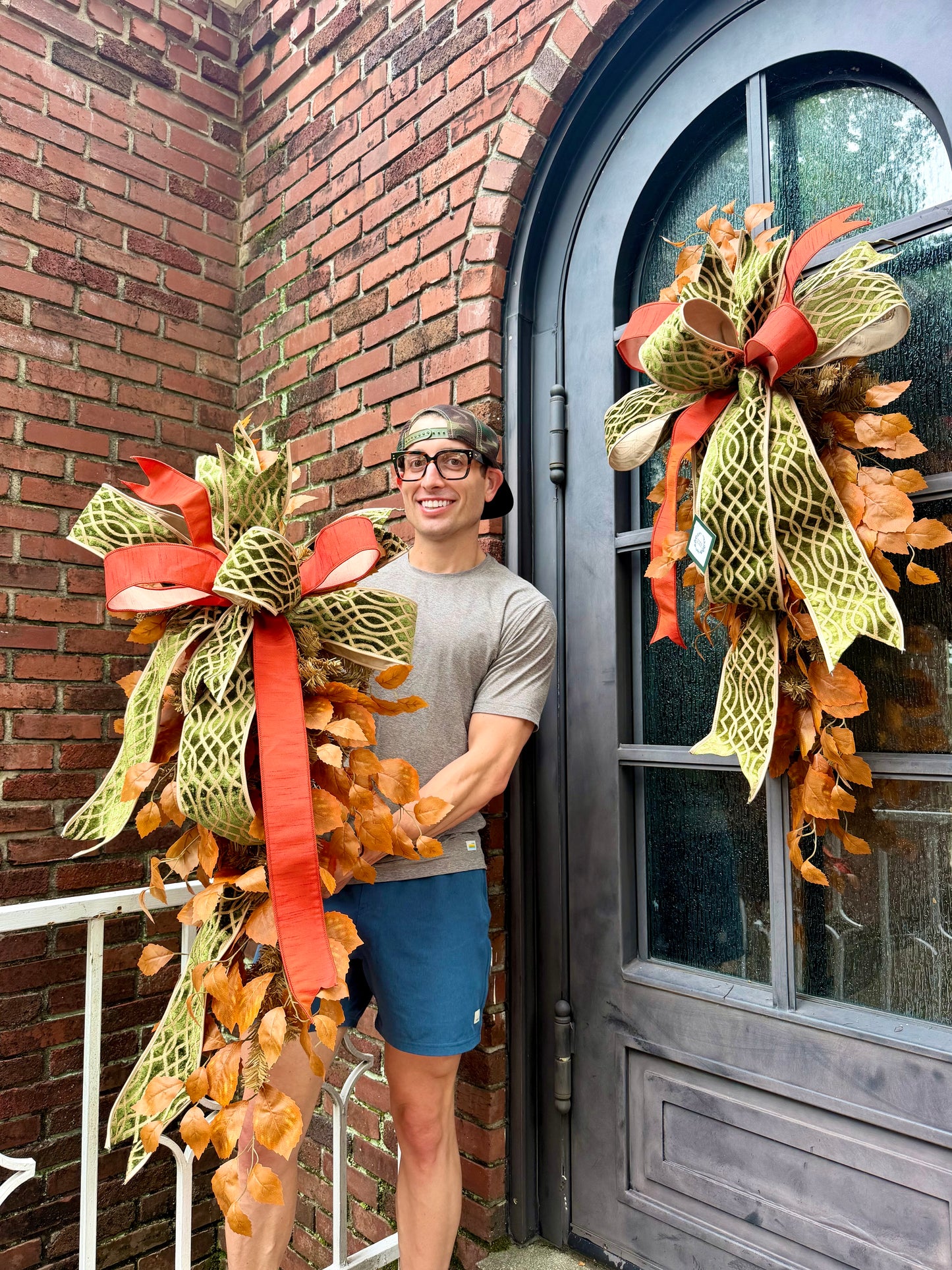 Handmade JME fall door swag made with faux fall leaves and paired with a beautiful green embroidered JME bow. About 3 feet long by 21 inches wide. *Some fluffing may be required upon receiving. ￼
