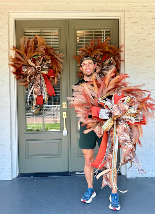 Faux natural and tans plume wreath. Paired with a JME hand tied bow of orange ribbon and fall tones. About 26 inches in diameter. * some fluffing may be required upon receiving.