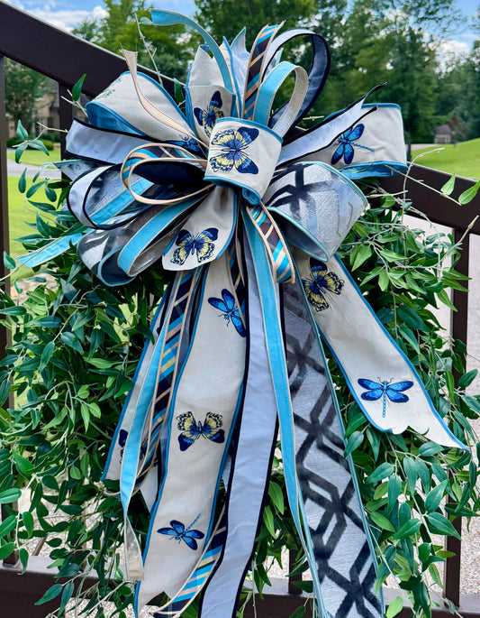 Large JME hand tied bow using embroidered butterfly and dragonfly ribbon paired with other JME HEAVY wired ribbons. About 22 inches wide by 33 inches long. *Some fluffing may be required upon receiving.