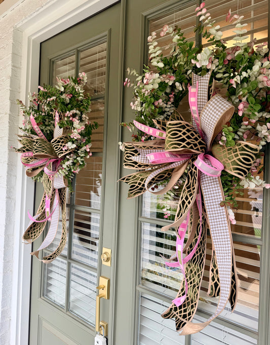 Faux eucalyptus wreath paired with a JME hand tied bow. About 24 inches in diameter.