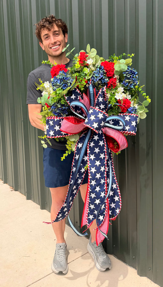 Handmade JME PATRIOTIC wreath. Paired with a JME hand tied bow of MIXED ribbons and a 4in star ribbon. About 24inches in diameter.
