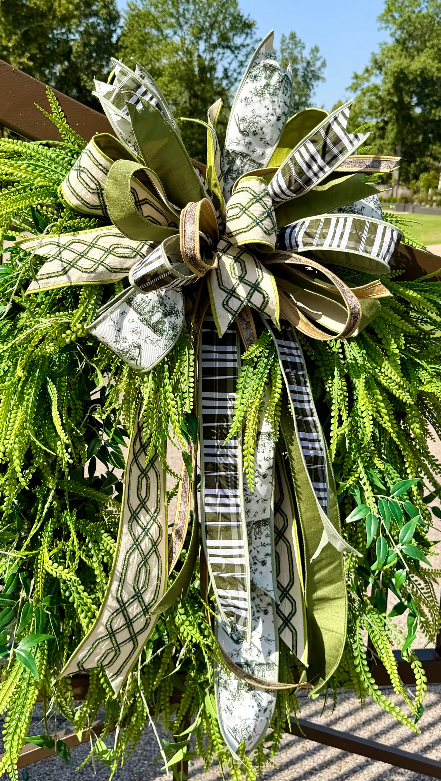 Green/neutral themed bow. Hand tied JME bow. Bow ONLY greenery not included   *some fluffing may be required upon receiving.