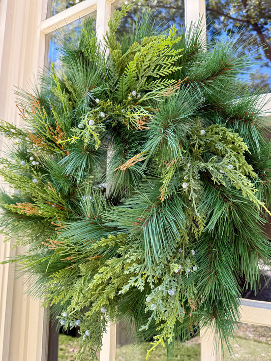 Faux mixed foliage wreath with Juniper and Cedar. 24 inches. Perfect for windows, mirrors, doors and more! Beautiful alone or with a simple bow.