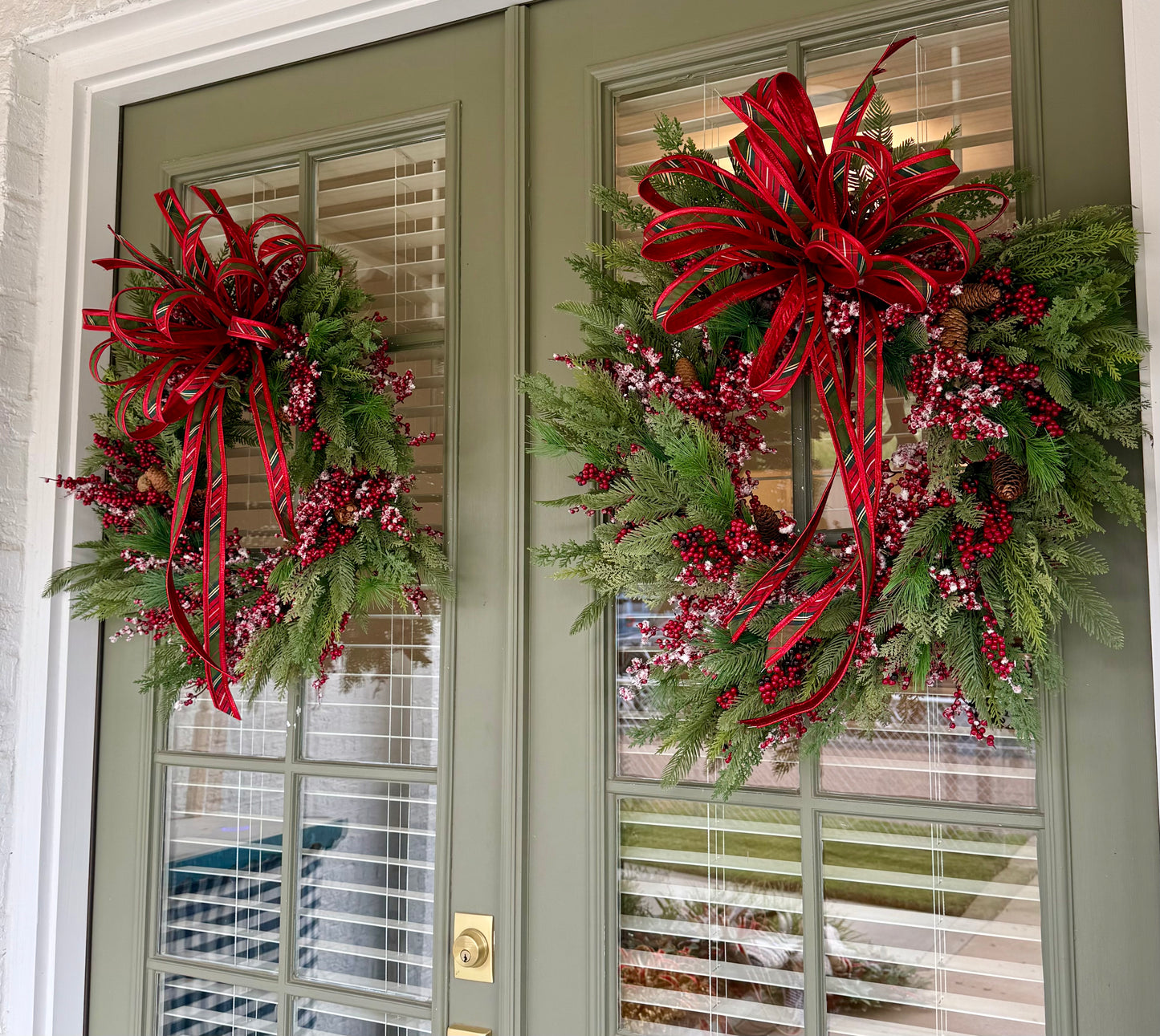 Faux Mixed berry wreath made by JME with a bias plaid hand tie JME bow. About 24 inches wide. ￼