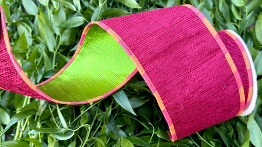 JME heavy wired ribbon. Red Apple Chenille with orange and coral piping with a green metallic back. 4“ x 10 yards.