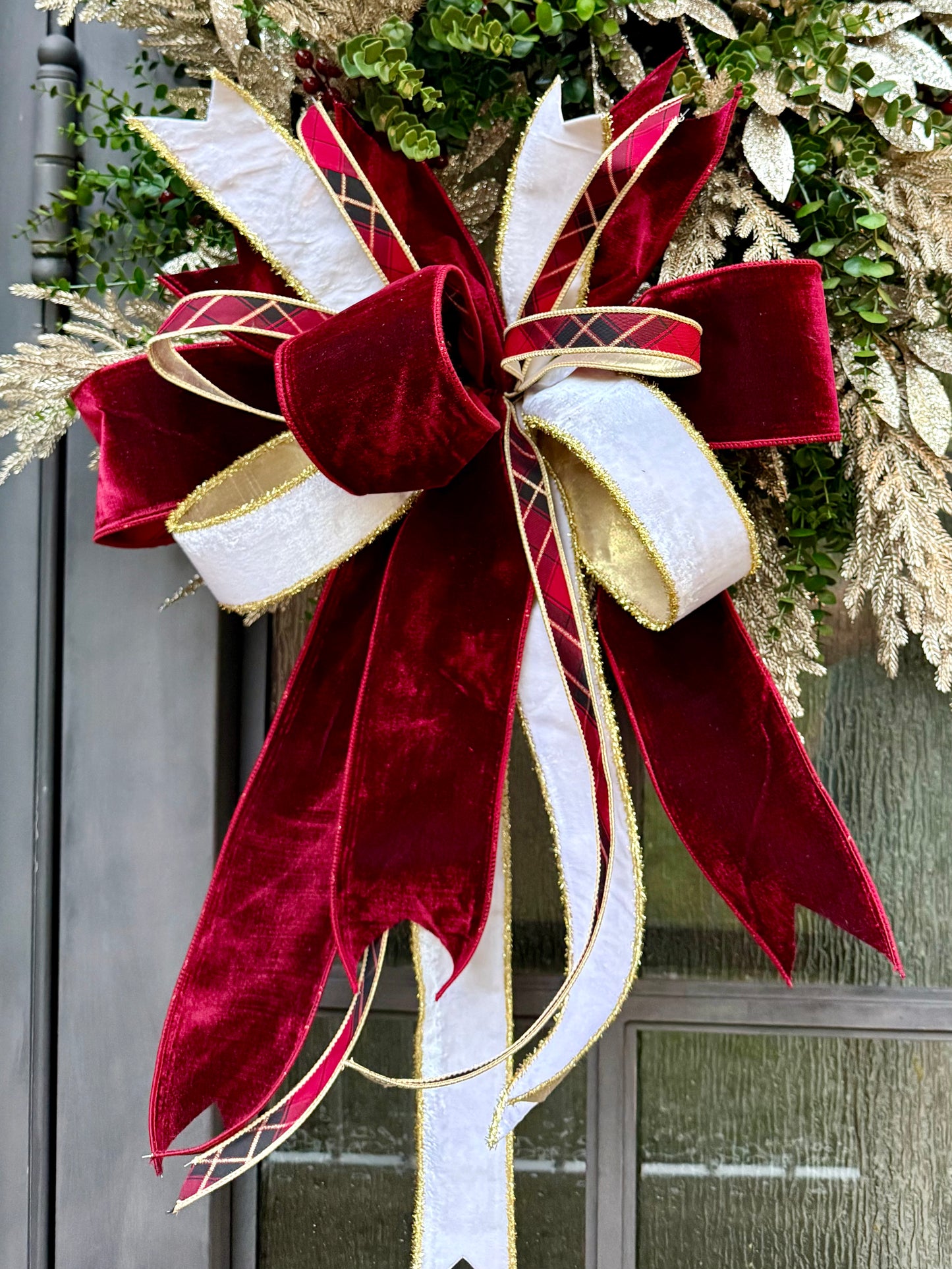 Burgundy and plaid. HANDMADE faux boxwood wreath with champagne touches and a JME hand-tied bow.