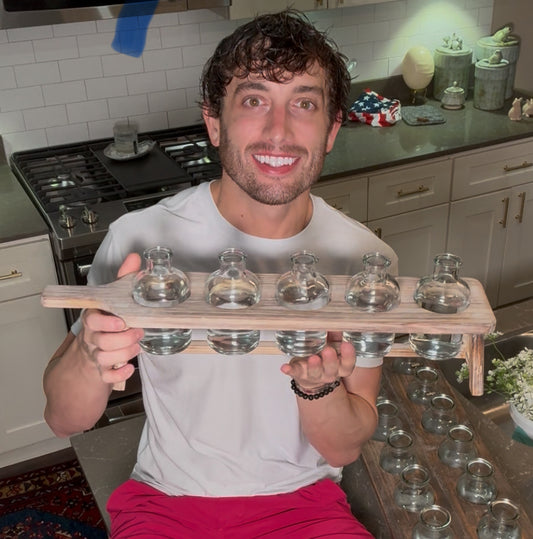 Easy arranger made of a cutting board to hold small bottles.