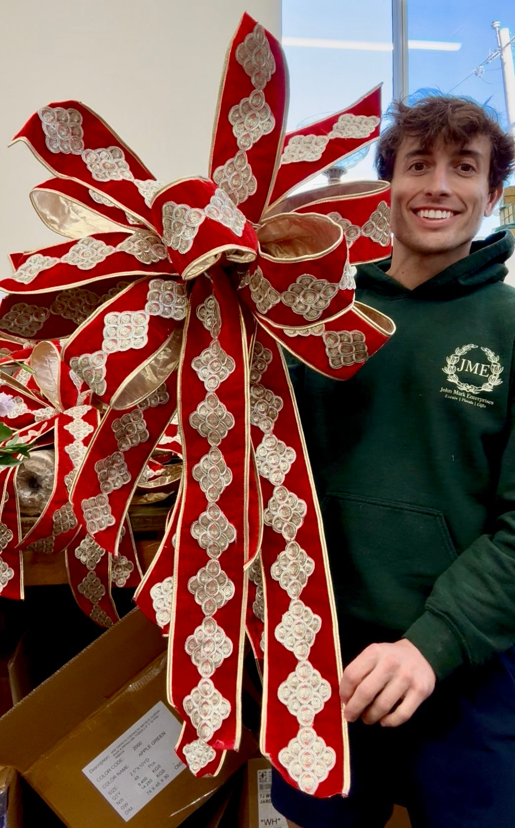 Lux JME red velvet bow with gold piping and beautiful trim work. Hand tied by JME. 10 yards of ribbon. Ribbon is 4inches wide. The bow measures approximately 2 feed wide by 3 feet long