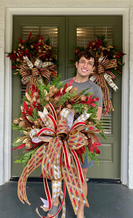 Red green gold faux wreath. Very full hand made wreath by JME and tied with a JME bow. About 30 inches wide