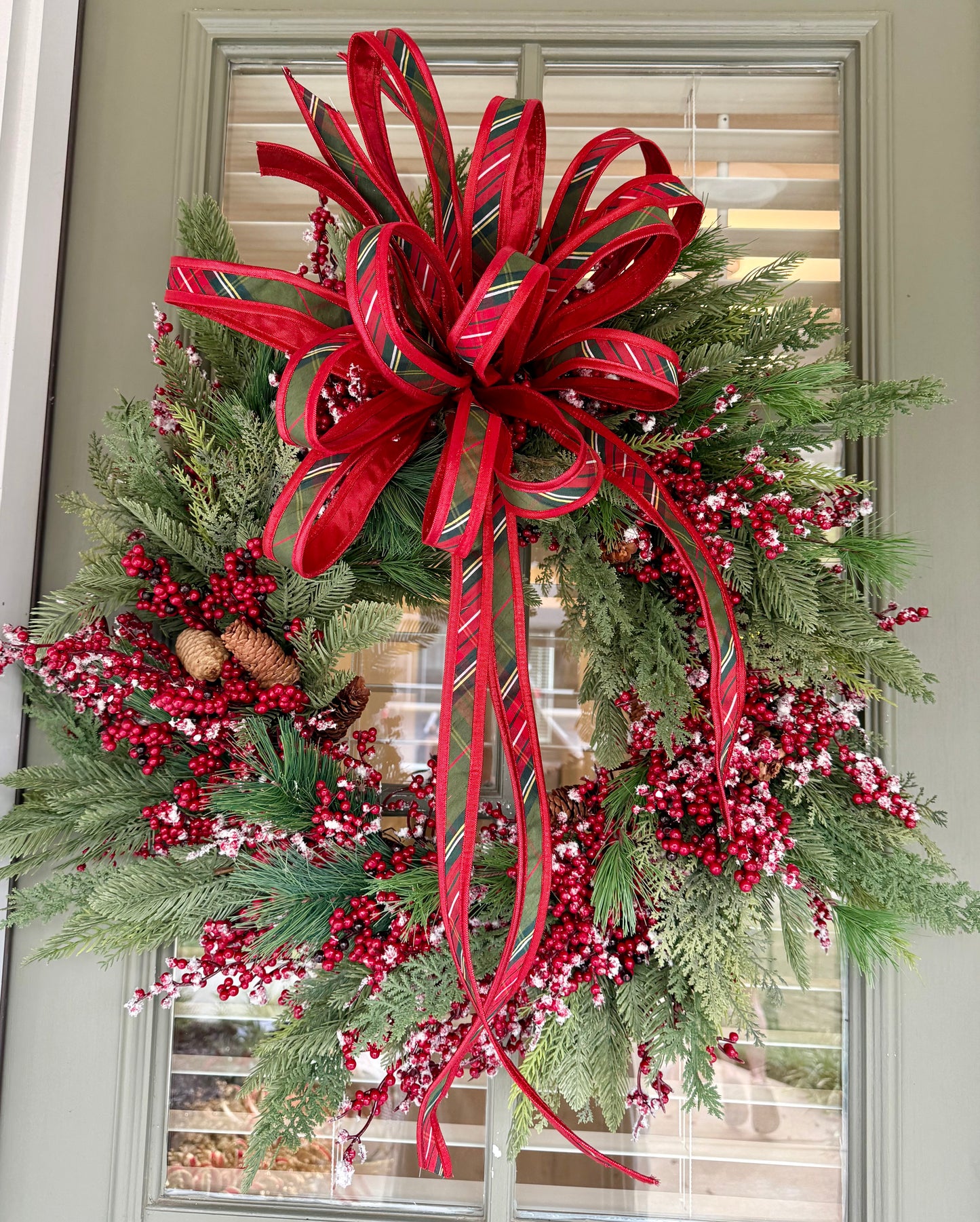 Faux Mixed berry wreath made by JME with a bias plaid hand tie JME bow. About 24 inches wide. ￼