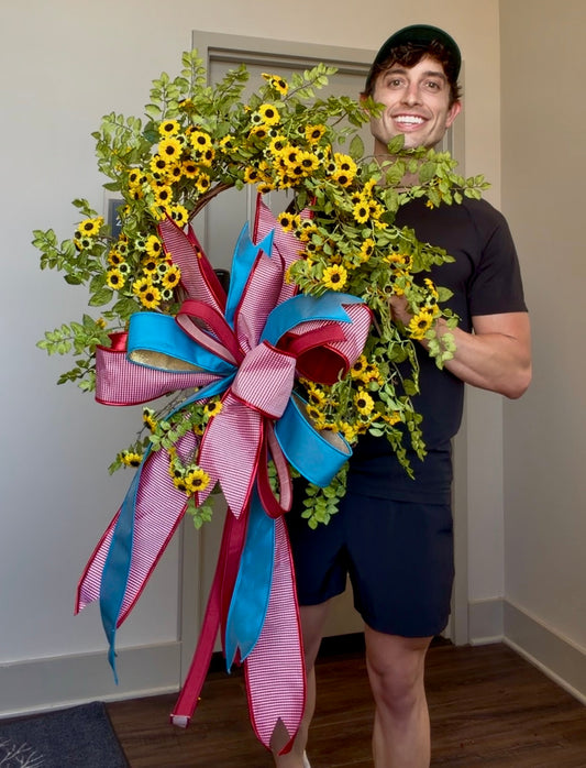 JME mini sunflower wreath WITH a JME hand tied patriotic bow. About 27 inches in diameter.