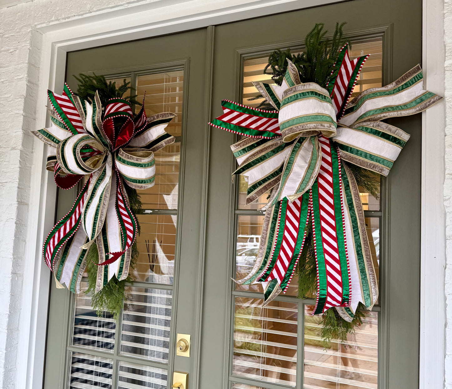 Cedar swag with a JME hand-tied bow using 6in velvet ribbon paired with a pattered ribbon. About 42 inches long