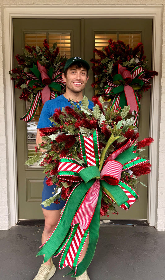 Red tinsel wreath with JME hand-tied bow. About 24 inches wide.