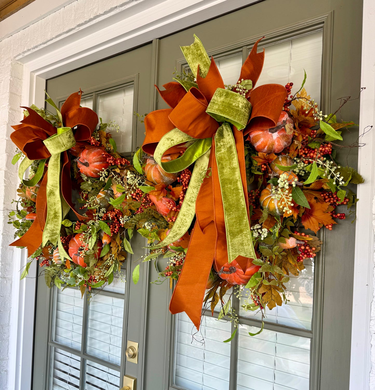 Faux pumpkin and green vine JME wreath WITH a hand tied JME bow. About 30 inches wide.