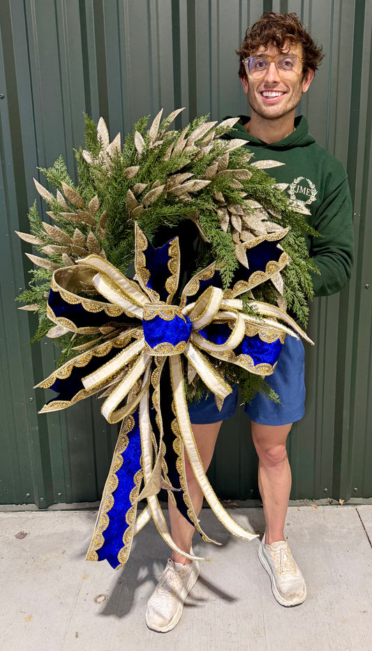 Lux faux winter wreath. With a lush JME handtied blue and white velvet bow. Perfect for all winter long.