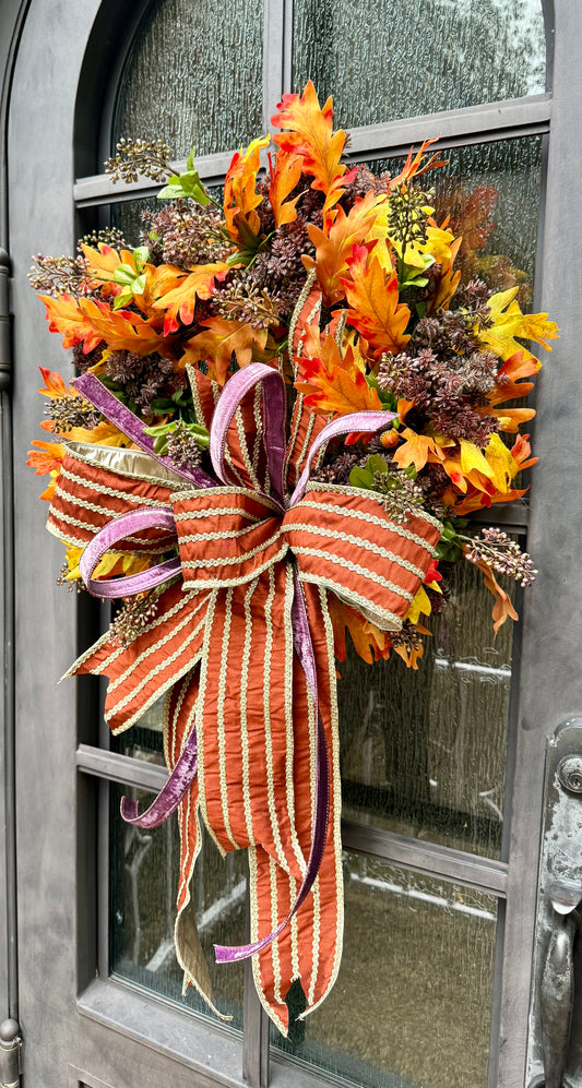 A touch of purple for fall! Handmade fall wreath with sedums in it. And a JME hand tied bow.