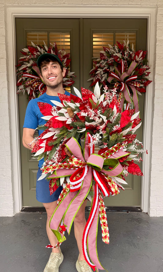 Candy Cane inspired wreath. Handmade by JME paired with a JM hand tied bow. About 24inches wide.