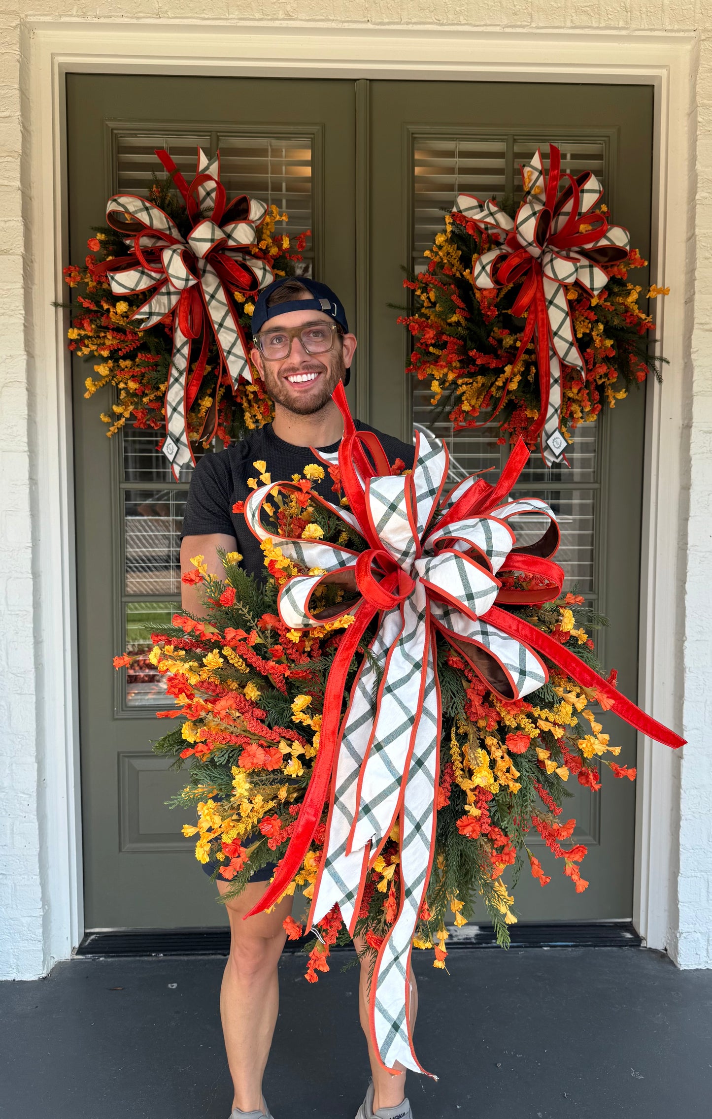 Handmade JME WREATH made of mixed foliage and paper flowers. With a JME orange velvet and green plaid bow. About 24in wide.SHIPPING MONDAY AUGUST 18th