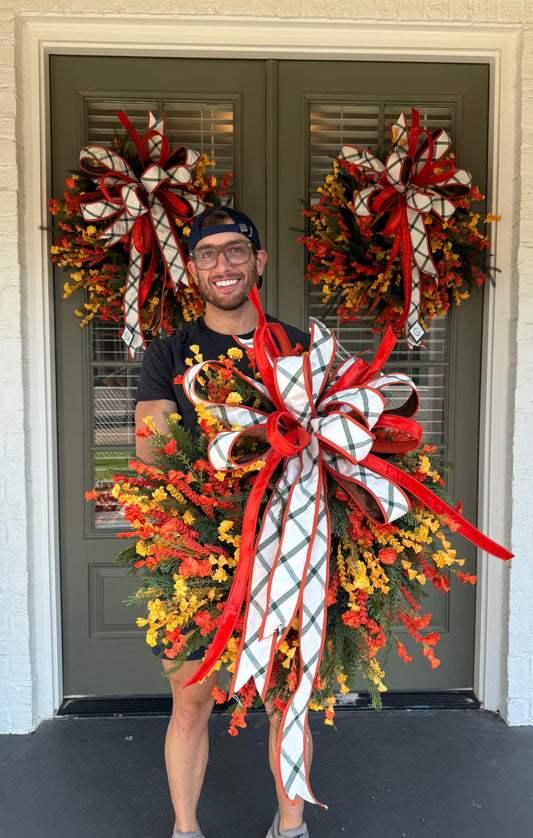 Handmade JME WREATH made of mixed foliage and paper flowers. With a JME orange velvet and green plaid bow. About 24in wide.SHIPPING MONDAY AUGUST 18th