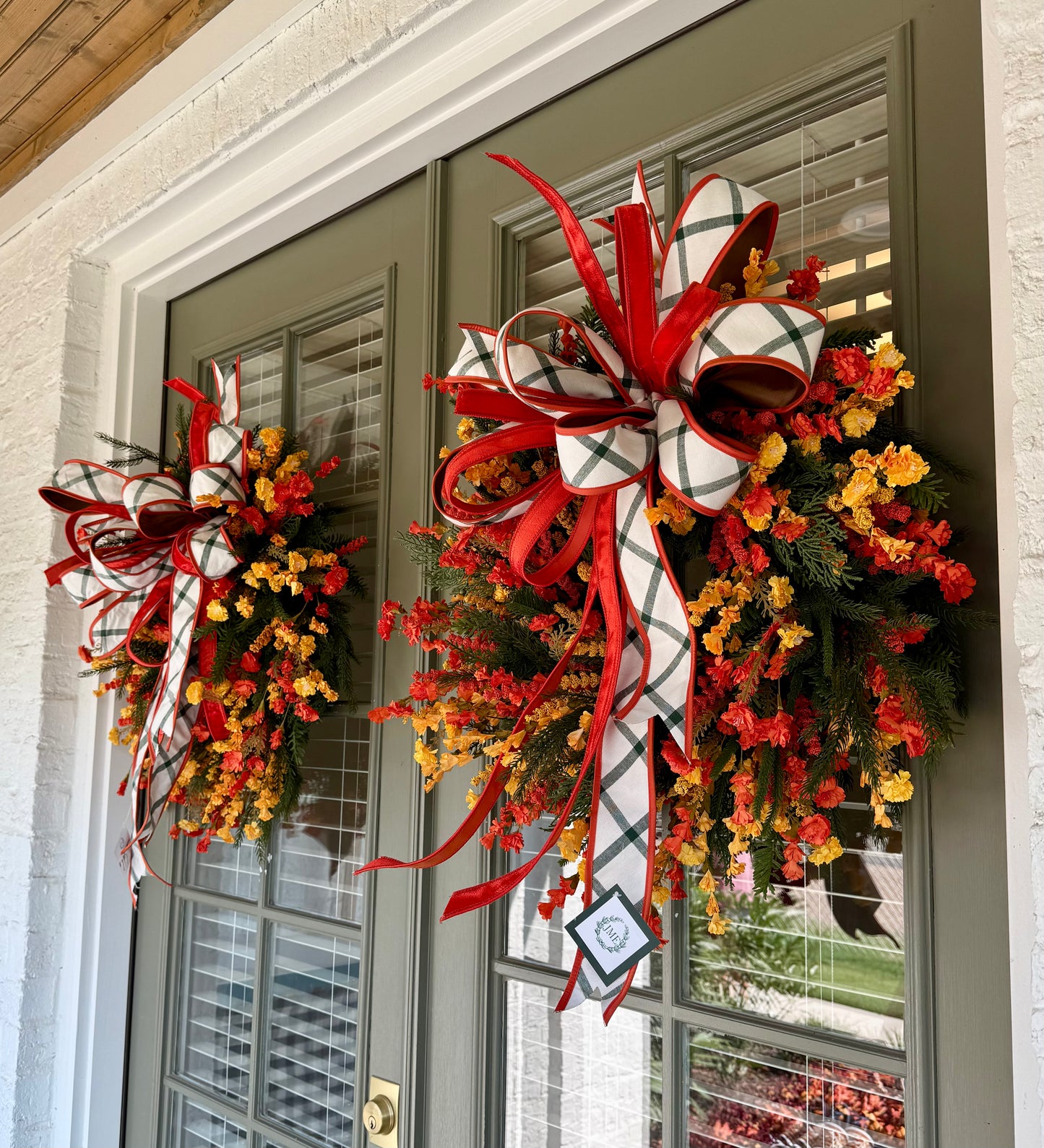 Handmade JME WREATH made of mixed foliage and paper flowers. With a JME orange velvet and green plaid bow. About 24in wide.SHIPPING MONDAY AUGUST 18th