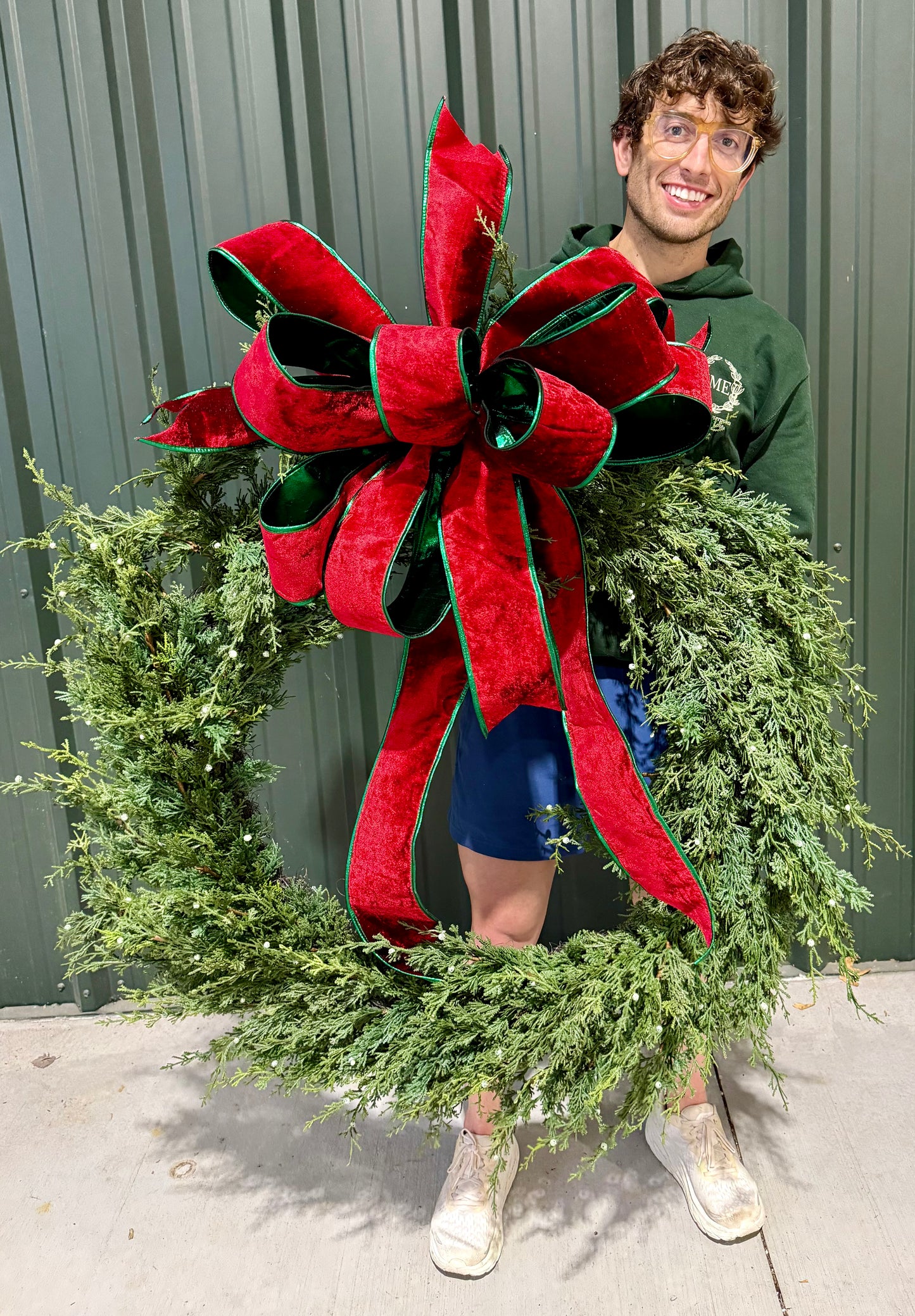 Faux Juniper with a JME hand tied red velvet bow. With green backing. Real touch 42 inches in diameter.