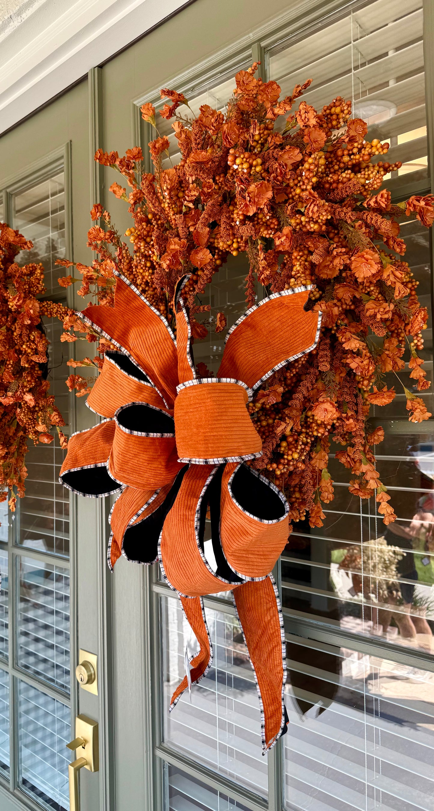 Handmade JME orange berry and paper flower wreath. Paired with a JME hand-tied orange corduroy though. About 24 inches wide. Shipping Monday August 18th.