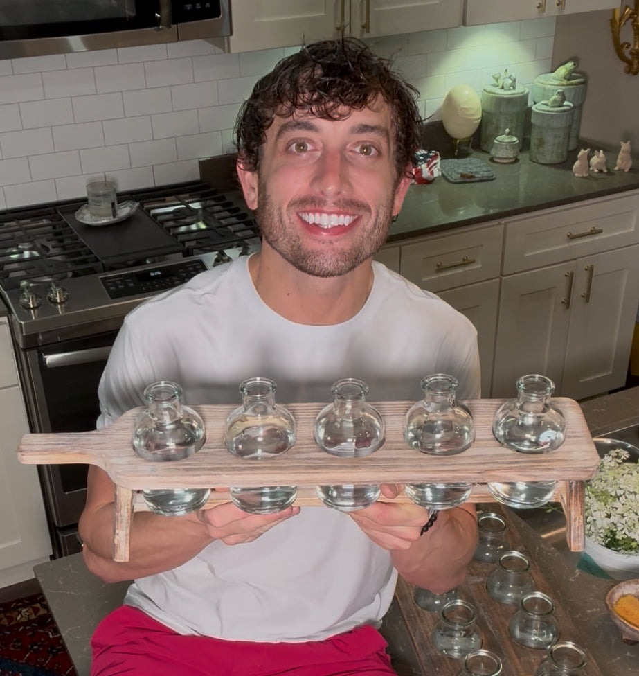 Easy arranger made of a cutting board to hold small bottles.