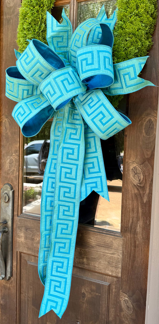 Hand tied JME bow from Greek key blue/aqua embroidered ribbon. 10 yards on the bow.