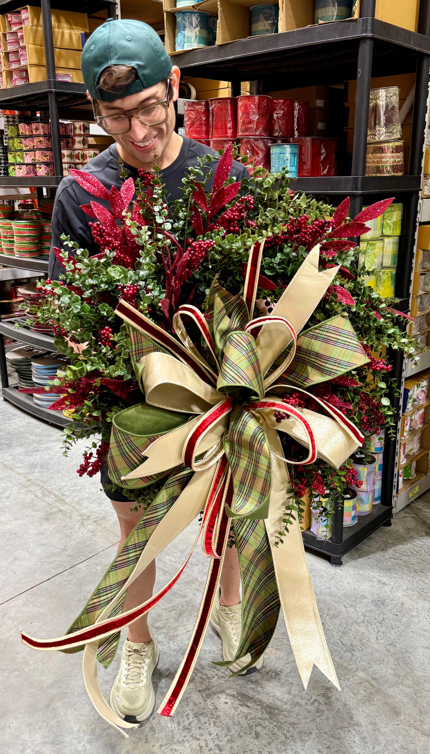 Handsome JME wreath. Made by JME paired with a hand tied bow by JM. About 24 inches wide.