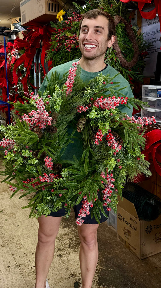 24 inch hand made by JME WREATH. Red snowberries with different textures of Christmas greenery.